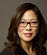 A woman wearing glasses. Description generated by AI