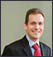A man wearing a suit and tie. Description generated by AI