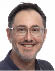 A man wearing glasses and a blue shirt. Description generated by AI