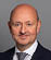 A man wearing a blue suit and tie. Description generated by AI