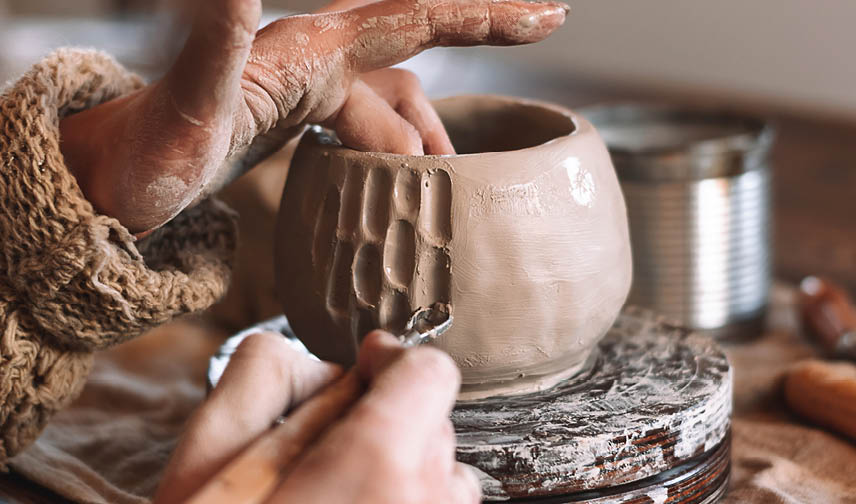 A person is making a pottery. Description generated by AI