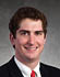 A man wearing a suit and tie with a red tie. Description generated by AI