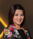 A woman wearing a floral jacket. Description generated by AI