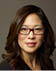A woman wearing glasses. Description generated by AI