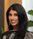 A woman wearing a black and white shirt. Description generated by AI
