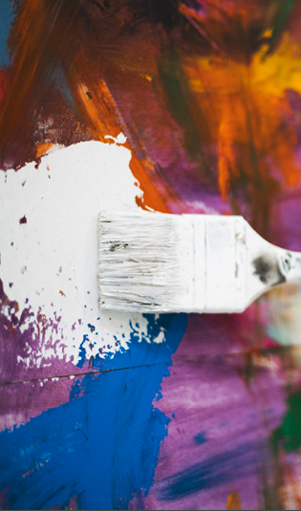 A man is painting a picture with a brush. Description generated by AI