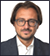 A man wearing a suit and tie. Description generated by AI