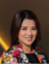 A woman wearing a floral jacket. Description generated by AI