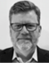 A man with a beard and glasses. Description generated by AI