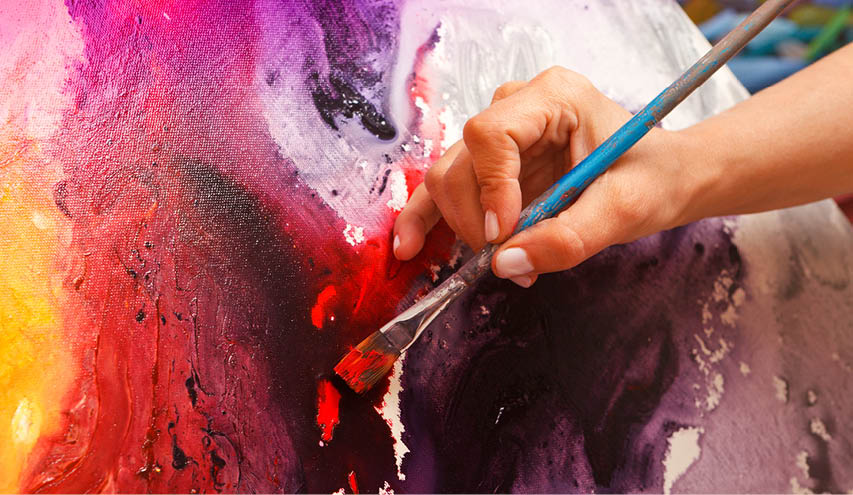A person is painting a picture with a blue brush. Description generated by AI