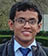 A man wearing glasses and a blue tie. Description generated by AI